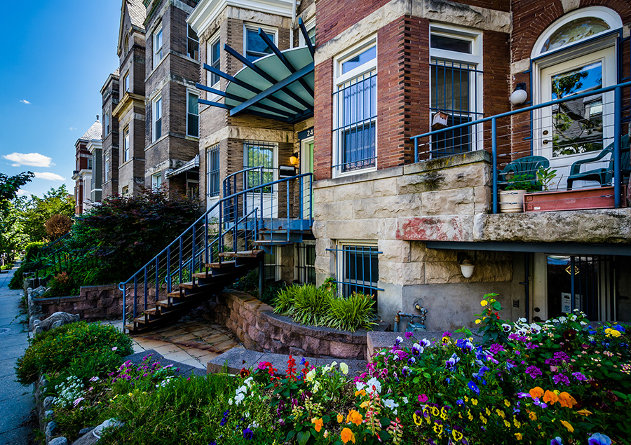 View of building with a small flower garden 